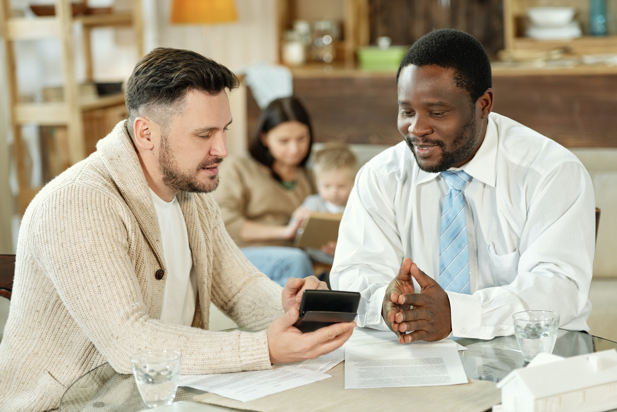 ethnic man consulting client on home loan